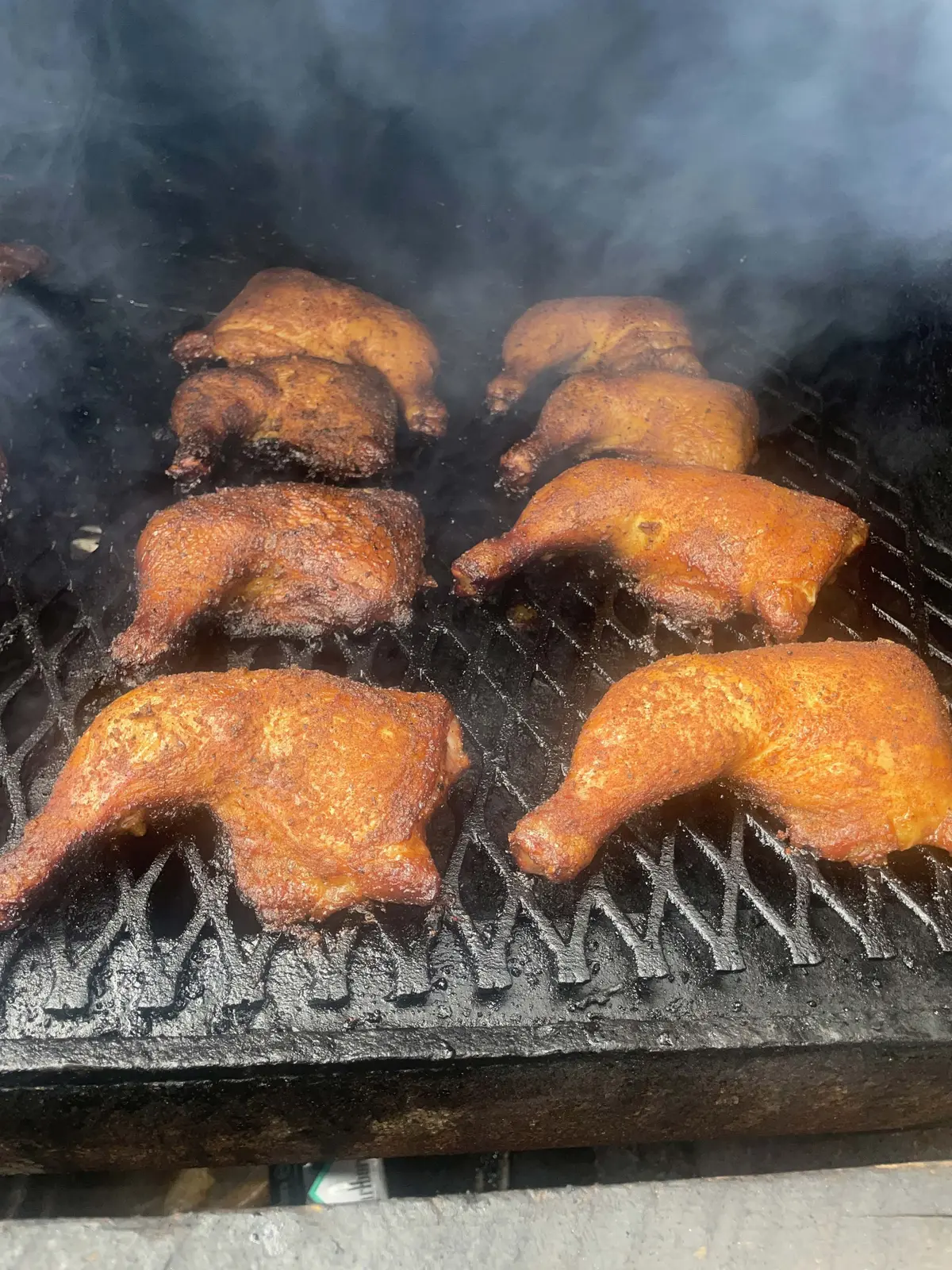 Chicken quarters taking on smoke on the pit